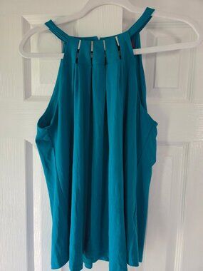 Jennifer Lopez deep teal top with accents at neckline